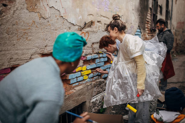 istock Street artists painting on wall 1411107113