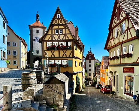 Tourists on the street of Rothenburg ob der Tauber, a well-preserved medieval town, which is famous a destination for tourists from around the world.