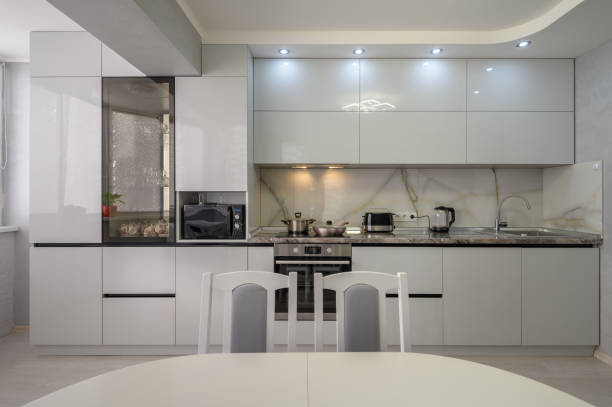 istock Interior of modern trendy white kitchen, front view 1411112569