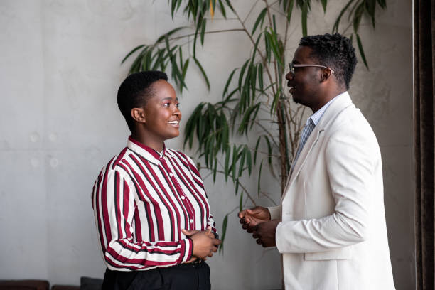 istock Two African-American coworkers having a talk at work 1411120166
