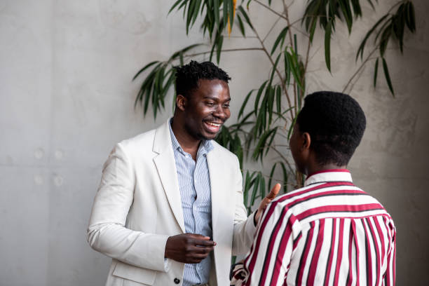 istock Young black man telling a joke to his coworker 1411120538