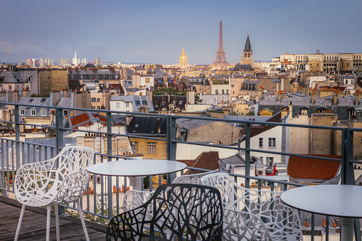 Eiffel tower and parisian roofs at golden sunrise Paris, France