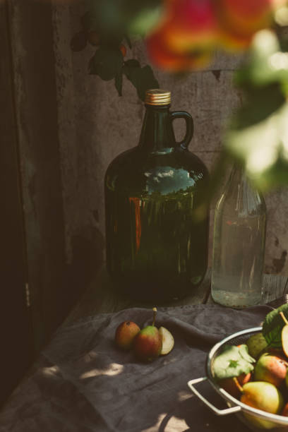 istock Retro still life, a large bottle for home winemaking on wooden table 1411123819