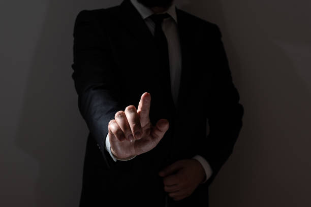 istock Businessman Pointing With One Finger On Important Messages. Executive In Suit Presenting Crutial Informations. Gentleman Showing Critical Announcement. 1411124538