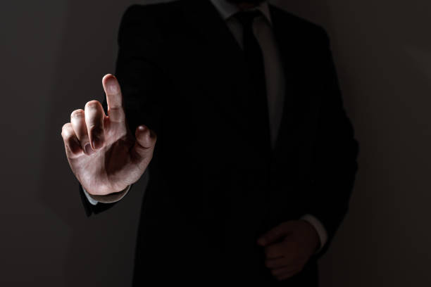 istock Businessman Pointing With One Finger On Important Messages. Executive In Suit Presenting Crutial Informations. Gentleman Showing Critical Announcement. 1411124543