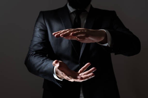 istock Businessman Pointing Important Message Between Hands. Man In Suit Presenting Crutial Informations Among Palms. Executive Showing Recent Announcements. New Ideas Displayed. 1411124653