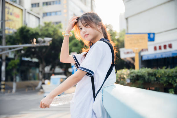 istock Beautiful asian girls returning home at dusk 1411130041