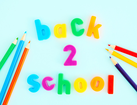 Back To School Message on a Blue Background with Colored Pencils
