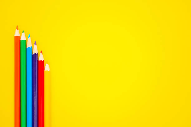 Back To School Background with Colored Pencils on Bright Yellow Background