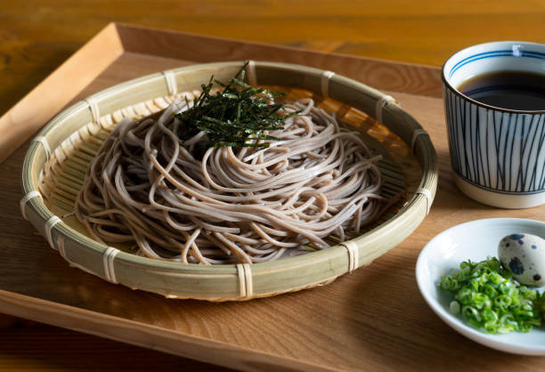 istock Zaru-soba and condiments on a wooden table. 1411133404