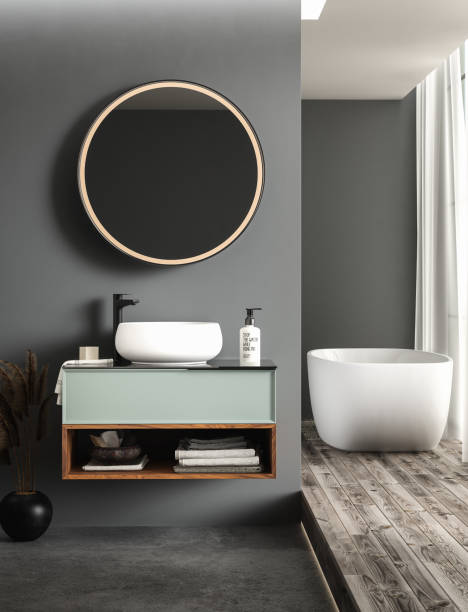 istock Modern bathroom interior with concrete flooring, white bathtub and white oval sink, front view 1411134417