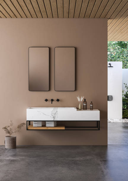 istock Modern bathroom interior with beige walls, marble basin with double mirror, bathtub and grey concrete floor. 1411134420