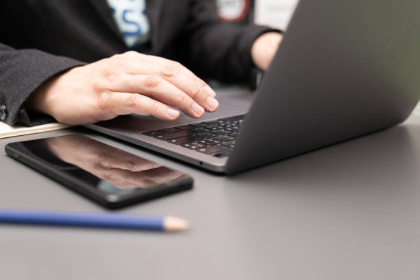 istock working on desk with laptop and smartphone. 1411134564