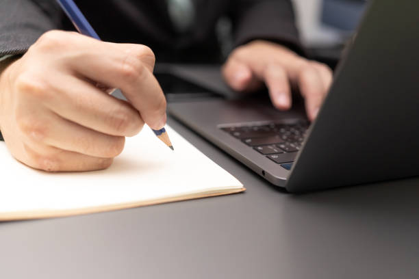 istock working on desk with laptop and smartphone. 1411135084