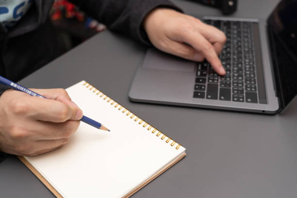 istock working on desk with laptop and smartphone. 1411135130