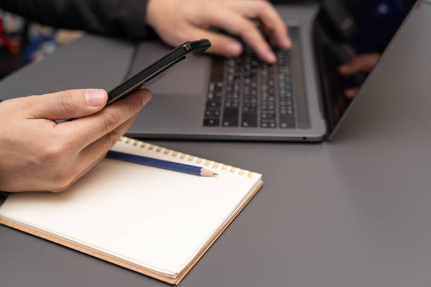 istock working on desk with laptop and smartphone. 1411135134