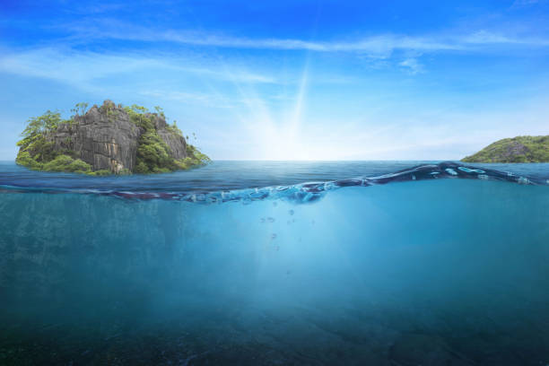 istock BLUE UNDER WATER waves and bubbles. Beautiful white clouds on blue sky over calm sea with sunlight reflection, Tranquil sea harmony of calm water surface. Sunny sky and calm blue ocean. 1411135734