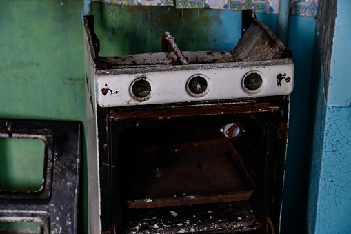 Old rusty gas stove in kitchen in abandoned apartment at ghost town Pripyat. Chernobyl exclusion zone