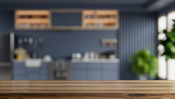 istock Wooden table top on blur kitchen room background,Modern kitchen room interior. 1411139816