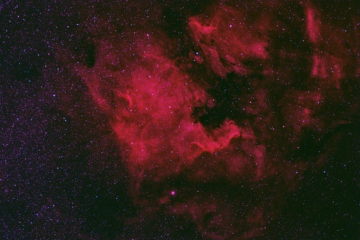 The North America Nebula (NGC 7000 or Caldwell 20), is an emission nebula near the constellation Cygnus. This image was taken with a full-spectrum modified camera with a narrow band pass filter that passively enhances the red, or H-alpha wavelength of light.  Combined exposure time 150 minutes