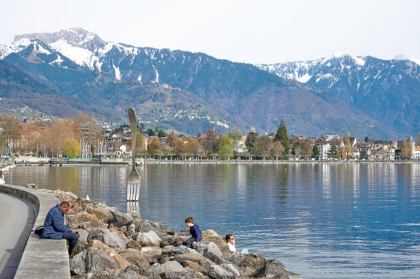 Vevey, Switzerland - April 12, 2022: people relaxing at the Fork sculpture in front of the Alimentarium museum on the shore of Lake Geneva.