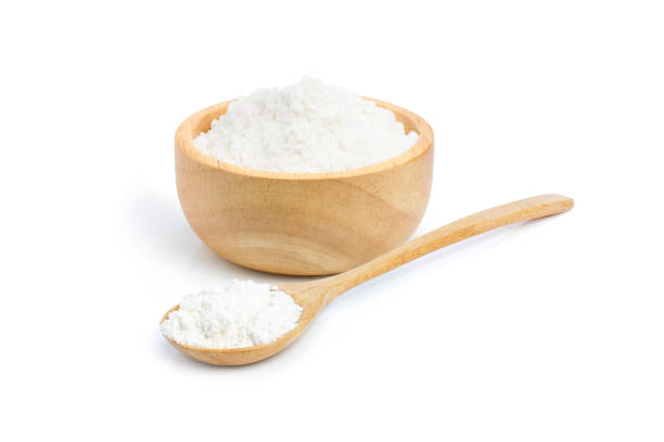 tapioca starch (potato flour or powder) in wooden bowl Closeup tapioca starch (potato flour or powder) in wooden bowl and spoon isolated on white background. hydroxide stock pictures, royalty-free photos & images