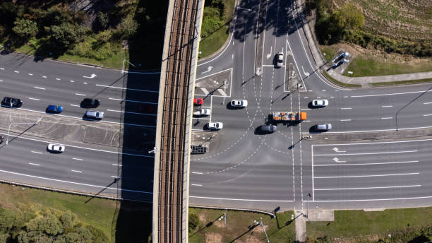 Busy Traffic Intersection And Light Rail Bridge Shot From Above