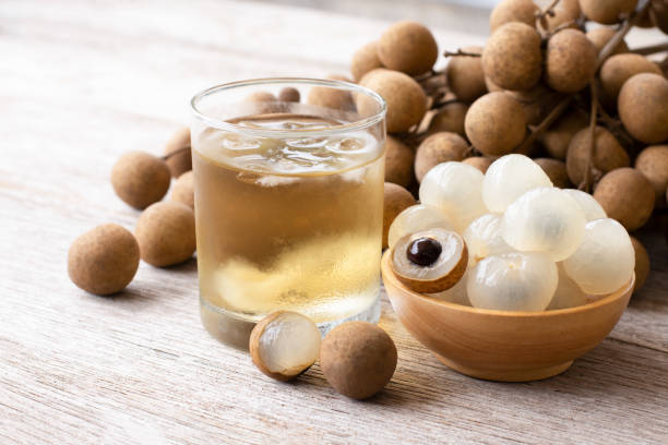 Longan juice and longan fruit Longan juice and longan fruit on wooden table background. longan stock pictures, royalty-free photos & images