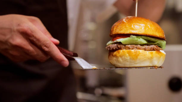 CU, Japanese men are making hamburgers.