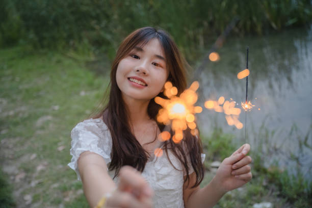 istock A girl who plays fireworks at night 1411148292