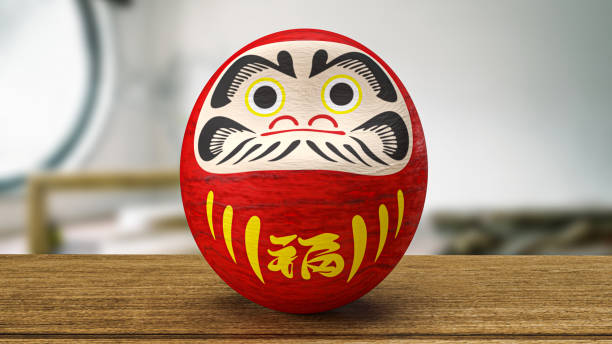 istock daruma Japanese doll on wood table 3d rendering 1411148374