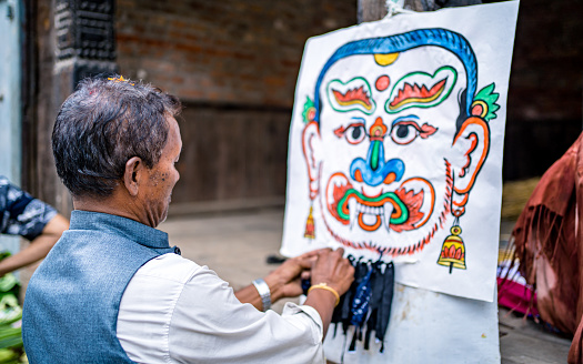 Newar community people making Ghantakarna statue on the day of Gathemangal Festival at ancient city at Bhaktapur, Nepal, on  Tuesday July 26, 2022, Nepal, on  Tuesday July 26, 2022