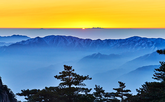 Sunrise at horizon over cloud-sea, Mountain Huangshan, China.