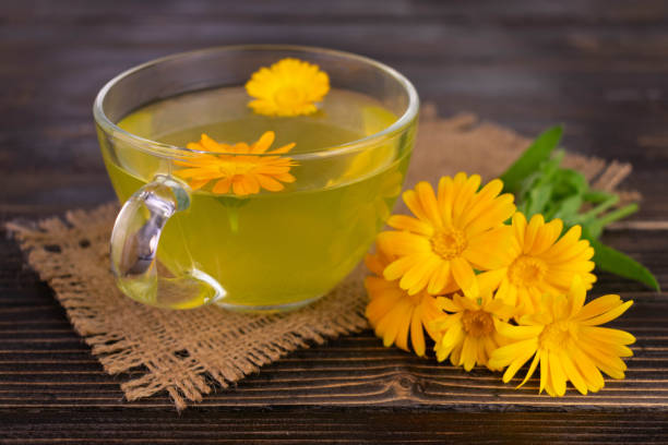 istock Medicinal tea from calendula flowers in a transparent cup.Close-up. 1411152479