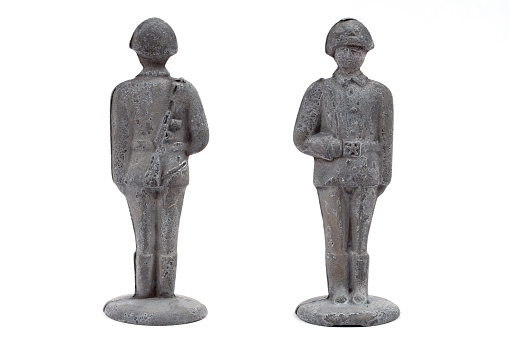 An old tin soldier. Front and rear view. An old soldier on a white background.