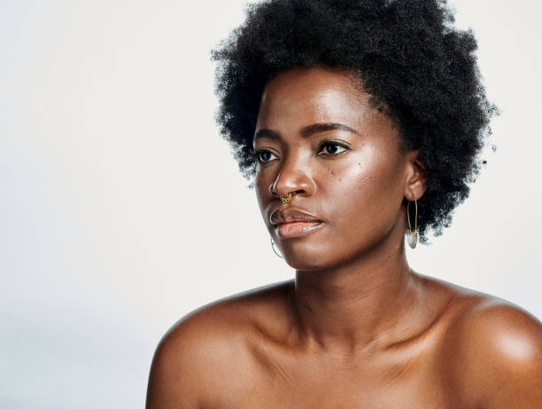 istock Natural hair afro model thinking and looking sad or unhappy while remembering self love struggles and body acceptance. Face and headshot of beautiful, fashionable and trendy woman in studio 1411155651