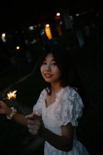 istock A girl playing fireworks at night 1411156319