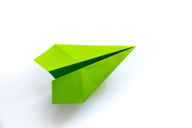 istock Green paper plane origami isolated on a white background 1411156455