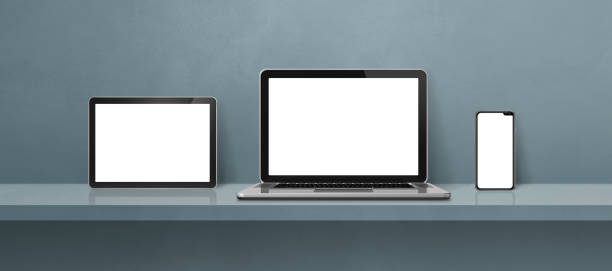 istock Laptop, mobile phone and digital tablet pc on grey wall shelf. Banner background 1411156537