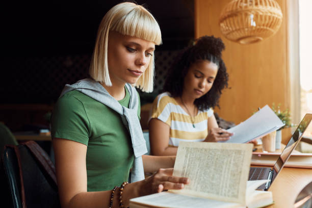 istock University student and her friend learning in a cafe. 1411157524