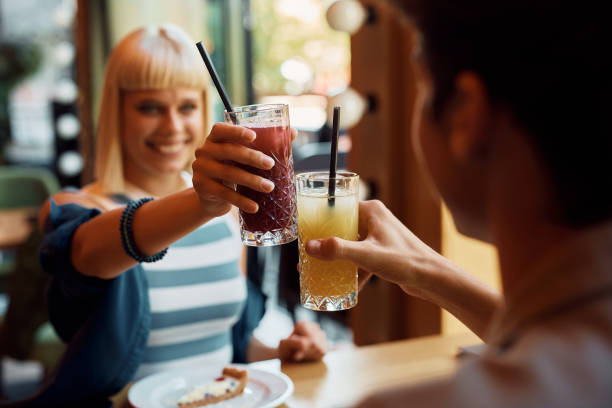 istock Close up of couple toasting while enjoying in a cafe. 1411157795