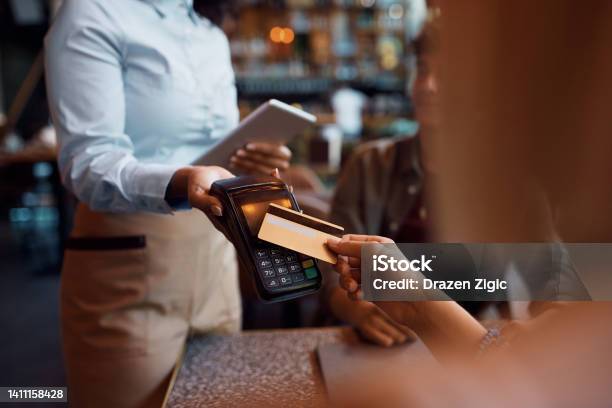 Close Up Of Woman Paying Contactless With Credit Card In A Cafe Stock Photo - Download Image Now