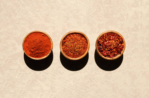 istock three wooden bowls with oriental spices are placed on a patchy beige background. 1411158641