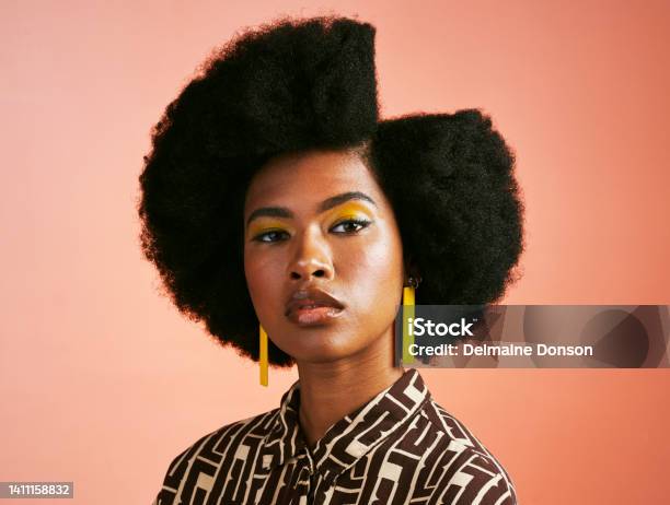 Fashionable Afro Cover Model With Fierce Powerful Attitude And Funky Trendy Hairstyle With A Symmetrical Side Part Powerful Portrait Of Intense Retro And Melanin Woman Against Studio Background Stock Photo - Download Image Now