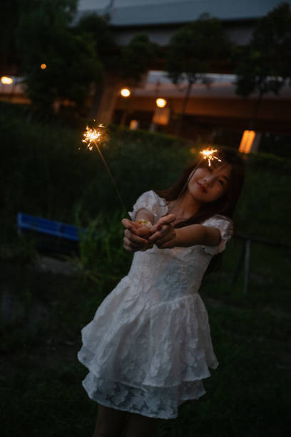 istock A girl playing fireworks at night 1411158946