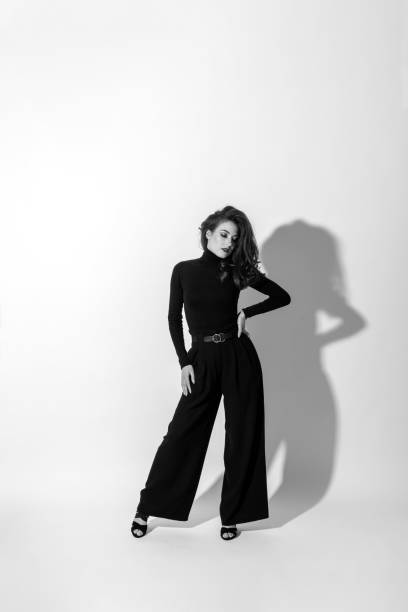 istock Woman with black outfit studio portrait on white background 1411168081