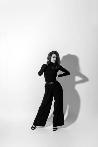 istock Woman with black outfit studio portrait on white background 1411168082