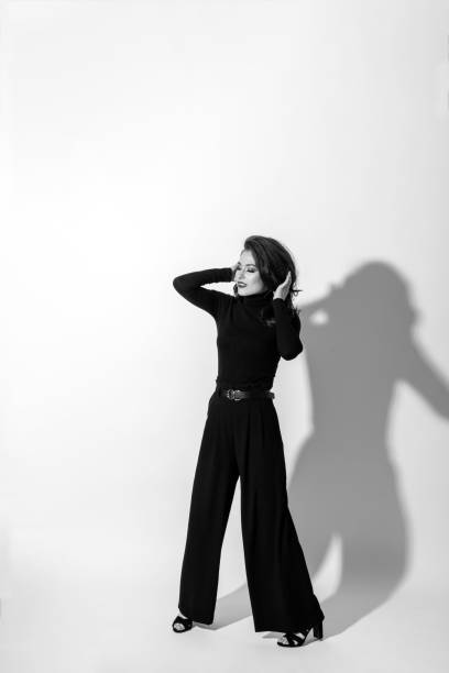 istock Woman with black outfit studio portrait on white background 1411168083