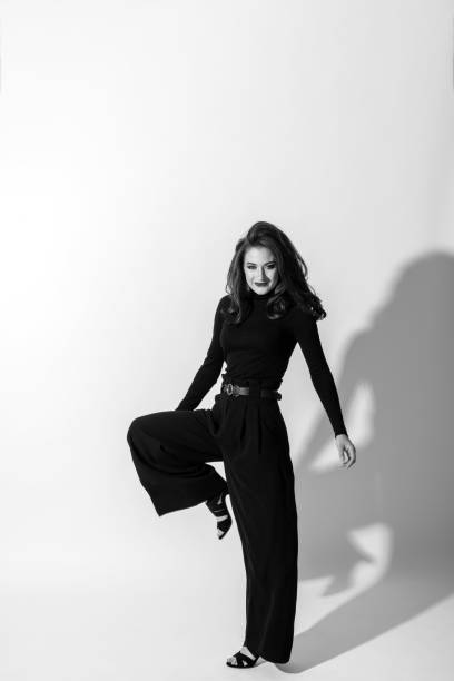 istock Woman with black outfit studio portrait on white background 1411168084