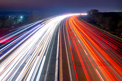 Night Car Traffic With Light Trails on a Suburban Highway